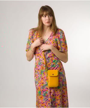 The 'Buzz' small cross body bag from Conkca London is handcrafted from genuine leather for a beautiful finish. A magnetic press-stud secures the fold-over top and conceals the natural and untreated 100% cotton lined central compartment. Ample storage space is provided by two slip pockets that are ideal for maintaining an organised bag. Comes with an adjustable leather strap alongside gold metal fittings. Adorned with the iconic Conkca logo and charm.