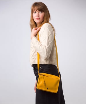 The 'Aurora' cross body bag from Conkca London elevates this classic design with a natural leather exterior for a beautifully smooth finish. A zip-over top conceals the central 100% cotton lined compartment alongside a handy slip pocket. Additional storage space is provided by a zipped pocket and slip pocket, ideal for on-the-go storage. The accessory comes with an adjutable leather strap secured with rustic gold metal fittings; this is all finished with the iconic Conkca London logo and charm.