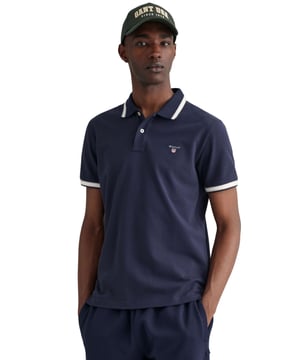 Elevate your wardrobe with our timeless Regular fit Short sleeves cotton piqué shirt. Featuring herringbone detailing on the collar and cuffs and an embroidered GANT shield on the chest, this sporty classic is made of lightweight, breathable fabric (2063005)
