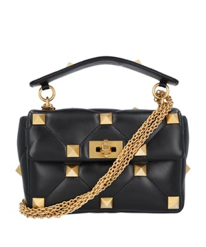 Black leather handbag with a quilted design and gold pyramid studs. It features a structured top handle, a gold-tone turn-lock closure, and elegant ring attachments. The bold stud detailing adds a luxurious and edgy touch to its classic silhouette
Dimensions L 23cm x H 17cm x W 7.5cm  Measurments:  width: 75 mm length: 230 mm height: 170 mm