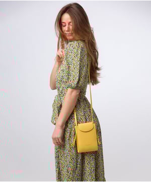 The 'Kiana' cross body phone bag from the Pure Luxuries Marylebone Collection is handcrafted from high-quality, genuine Nappa leather with a natural super-soft touch. The minimalistic fold-over top is secured by a gold-coloured magnetic press stud. This practical design is the perfect place to keep your phone safe and features a tassel design on the exterior. Lined with 100% cotton for a flawless finish and comes with a matching and adjustable slim leather strap with a maximum drop length of 65cm. The minimalist Pure Luxuries logo is embossed in gold foil for a beautifully simple finishing touch.