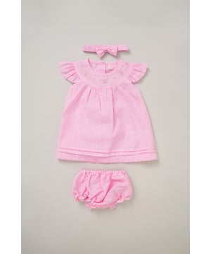 This outfit set by Rockabye Baby Boutique includes a sweet dress, matching knickers, and a coordinating bow headband. Perfect for special occasions or everyday wear, this set combines style, comfort, and playful detail for your little one’s wardrobe.