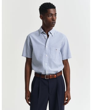 
 This short-sleeved shirt is crafted in a woven seersucker stripe for a textured look and cut in a regular fit. It features a classic button-down collar, a chest pocket with the GANT shield graphic, a curved hem, and a box pleat with our signature locker loop at the back.


Regular, untucked fit
Button-down collar
Box pleat and locker loop at back
GANT graphic embroidered at chest pocket

100% Cotton
3250050