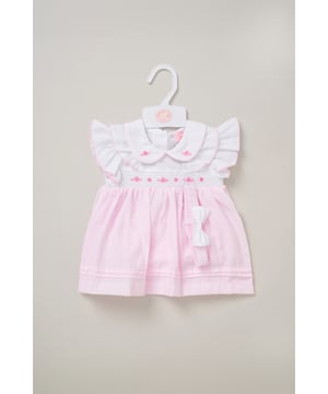 This outfit set by Rockabye Baby Boutique includes a sweet dress, matching knickers, and a coordinating headband, all decorated with an adorable bow theme. Perfect for special occasions or everyday wear, this set combines style, comfort, and playful detail for your little one’s wardrobe.