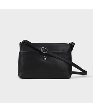 Redefine elegance with the ‘Sandra’ soft Nappa leather crossbody bag, a perfect fusion of luxury, craftsmanship, and practicality. Beautifully handcrafted from the finest full-grain soft Nappa leather, this multifunctional crossbody bag is designed for everyday use. Whether you're heading to work, a casual outing, or an evening event, the ‘Sandra’ crossbody bag is your go-to accessory for effortless sophistication and refined style. Premium Full-Grain Nappa Leather – Crafted from the softest and most supple genuine leather, offering a luxurious touch and exceptional durability. Smart & Functional Design – Smooth zippers open to a roomy main compartment for easy organisation and secure storage. Fully lined with fresh cream polyester fabric, allowing you to easily spot your essentials. Multipocket - Secured Front slip pocket and back zip pocket to slide in your essentials. Adjustable Leather Shoulder Strap – Designed for custom comfort, allowing you to adjust the length of the strap to suit your size. Lightweight & Versatile – A perfect everyday companion, seamlessly blending style and functionality. Signature Assots ‘Swan’ Collection – Embellished with the iconic ‘Swan’ logo, symbolising elegance, grace, and superior craftsmanship. Additional Internal Features - Zip pocket for car keys and house keys. Slip-in pocket for other essentials. Fittings Colour: Silver, Composition: Body: 100% Genuine Leather, Lining: Polyester. Size- W22cm x H16cm x D7cm.
