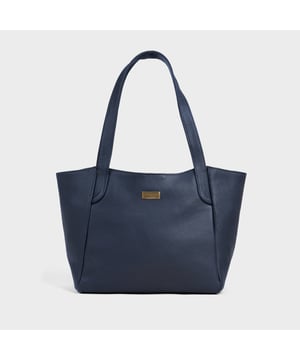 Beautifully handcrafted from the Assots Signature 'California' soft pebble grain genuine leather, the ‘Urban Tote’ is the ultimate blend of style, sophistication, and practicality. Designed for modern professionals, it features a secure magnetic closure and a spacious, fully lined interior, offering ample room for work essentials such as folders, diaries, notebooks, and tablets. Whether you're heading to a business meeting, a casual day out, or an evening event, this timeless leather tote ensures you stay organised and effortlessly stylish wherever you go. Luxuriously Soft Leather – Crafted from full-grain pebble leather with a buttery-soft, sumptuous feel. Spacious & Secure – Magnetic closure opens to a roomy, expertly lined interior, offering both style and functionality. Comfortable Carry – Extra-long shoulder handles ensure a secure, slip-free fit, even over an overcoat. Organised Storage – Internal secured zip pocket keeps your mobile phone, car keys, and house keys safe and accessible. Elegant Finishing Touch – Adorned with the signature Assots London brushed antique gold metal logo for a refined, premium look. Fittings Colour: Clean Brass, Composition: Body: 100% Genuine Leather, Lining: Polyester. Size- W41cm x H24cm x D12cm.
