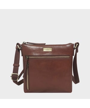 The Assots timeless design 'Rue' crossbody bag is beautifully handcrafted from the finest Italian finish genuine leather. Effortlessly stylish, this real leather crossbody features four zip pockets to organise your essentials when you're out and about. Ideal as an everyday bag, the 'Rue' is a must-have addition to your collection of luxurious leather handbags. Secured zip top closure opens to a fully lined and roomy interior. Pure cotton fabric lining used in natural beige making it a free from plastic product. Secured two zip pockets at the front to slide in your essentials such as face covering, smart phone and more. Back zip pocket for quick and easy access to your essentials. Adjustable long webbing shoulder strap handle for a comfortable carry. Lightweight. Adorned with the inimitable Assots London clean finish gold metal logo at the front. Fittings colour: Antique Brass. Composition: Body: 100% Genuine Leather. Lining: Pure Cotton. DISCLAIMER: All pictures shown are for illustration purposes only. Actual product colour may vary due to different ambience lighting or the screen display settings. Size- W22cm x H21cm x D3cm.
