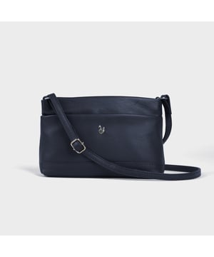 Redefine elegance with the ‘Sandra’ soft Nappa leather crossbody bag, a perfect fusion of luxury, craftsmanship, and practicality. Beautifully handcrafted from the finest full-grain soft Nappa leather, this multifunctional crossbody bag is designed for everyday use. Whether you're heading to work, a casual outing, or an evening event, the ‘Sandra’ crossbody bag is your go-to accessory for effortless sophistication and refined style. Premium Full-Grain Nappa Leather – Crafted from the softest and most supple genuine leather, offering a luxurious touch and exceptional durability. Smart & Functional Design – Smooth zippers open to a roomy main compartment for easy organisation and secure storage. Fully lined with fresh cream polyester fabric, allowing you to easily spot your essentials. Multipocket - Secured Front slip pocket and back zip pocket to slide in your essentials. Adjustable Leather Shoulder Strap – Designed for custom comfort, allowing you to adjust the length of the strap to suit your size. Lightweight & Versatile – A perfect everyday companion, seamlessly blending style and functionality. Signature Assots ‘Swan’ Collection – Embellished with the iconic ‘Swan’ logo, symbolising elegance, grace, and superior craftsmanship. Additional Internal Features - Zip pocket for car keys and house keys. Slip-in pocket for other essentials. Fittings Colour: Silver, Composition: Body: 100% Genuine Leather, Lining: Polyester. Size- W22cm x H16cm x D7cm.