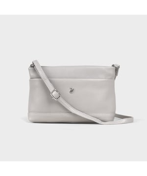 Redefine elegance with the ‘Sandra’ soft Nappa leather crossbody bag, a perfect fusion of luxury, craftsmanship, and practicality. Beautifully handcrafted from the finest full-grain soft Nappa leather, this multifunctional crossbody bag is designed for everyday use. Whether you're heading to work, a casual outing, or an evening event, the ‘Sandra’ crossbody bag is your go-to accessory for effortless sophistication and refined style. Premium Full-Grain Nappa Leather – Crafted from the softest and most supple genuine leather, offering a luxurious touch and exceptional durability. Smart & Functional Design – Smooth zippers open to a roomy main compartment for easy organisation and secure storage. Fully lined with fresh cream polyester fabric, allowing you to easily spot your essentials. Multipocket - Secured Front slip pocket and back zip pocket to slide in your essentials. Adjustable Leather Shoulder Strap – Designed for custom comfort, allowing you to adjust the length of the strap to suit your size. Lightweight & Versatile – A perfect everyday companion, seamlessly blending style and functionality. Signature Assots ‘Swan’ Collection – Embellished with the iconic ‘Swan’ logo, symbolising elegance, grace, and superior craftsmanship. Additional Internal Features - Zip pocket for car keys and house keys. Slip-in pocket for other essentials. Fittings Colour: Silver, Composition: Body: 100% Genuine Leather, Lining: Polyester. Size- W22cm x H16cm x D7cm.