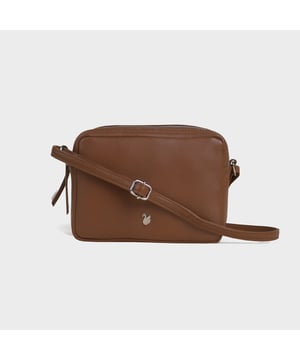 Redefine elegance with the ‘Avon’ soft Nappa leather crossbody bag, a perfect fusion of luxury, craftsmanship, and practicality. Expertly handcrafted from the finest full-grain soft Nappa leather, this premium bag is designed for those who appreciate timeless sophistication and effortless style. Whether you're heading to work, a casual outing, or an evening event, the ‘Avon’ crossbody bag is your go-to accessory for effortless sophistication and refined style. Premium Full-Grain Nappa Leather – Crafted from the softest and most supple genuine leather, offering a luxurious touch and exceptional durability. Smart & Functional Design – Double zipped compartments for easy organisation and secure storage. Spacious interior to accommodate your daily essentials with ease. Adjustable Leather Shoulder Strap – Designed for custom comfort, allowing you to wear it as a crossbody or shoulder bag. Lightweight & Versatile – A perfect everyday companion, seamlessly blending style and functionality. Signature Assots ‘Swan’ Collection – Embellished with the iconic ‘Swan’ logo, symbolising elegance, grace, and superior craftsmanship. Additional Internal Features - Slip-in pocket for your mobile phone, car keys and house keys. Fittings Colour: Silver. Composition: Body: 100% Genuine Leather, Lining: Polyester. Size: 14cm x 20cm x 7cm
