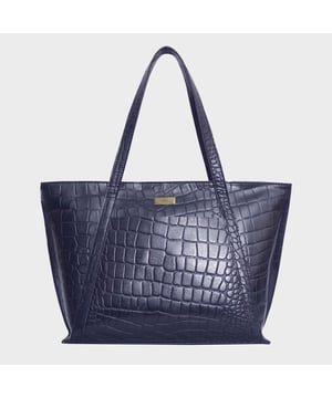 The ‘Agnes’ unlined tote bag is beautifully handcrafted with premium Croc&nbsp;embossed genuine leather for that designer look. It features slip-in&nbsp;pockets both in the front and back of the bag to slide in your daily essentials.&nbsp;This Croc Leather shopper is designed to ensure you don’t run out of space and have ample room for your necessities when you’re out and about. Walk in style with ‘Agnes’, the perfect travel companion ideal for all occasions. Secured zip top closure opens to an unlined interior. Slip pockets in the front and back of the bag. Fits a 13-inch laptop. Lightweight. Double Stitching on the handles for extra reinforcement. Reinforced base to avoid bulging when stuffed. Unlined shopper to maintain the natural leather look of the bag. Leather shoulder handle for easy pick up and go. Adorned with the inimitable Assots London brushed gold clean finish logo. Fittings colour: Antique Brass. Composition: Body: 100% Genuine Leather. Lining: Natural Cotton Lining.
DISCLAIMER: All pictures shown are for illustration purpose only. Actual product colour may vary due to different ambience lighting or the screen display settings. Size- W42cm x H28cm x D10.5cm.