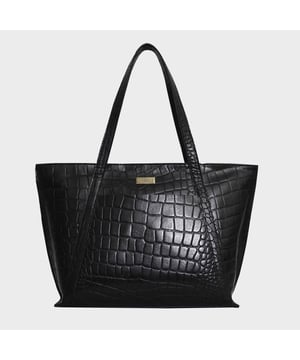 The ‘Agnes’ unlined tote bag is beautifully handcrafted with premium Croc&nbsp;embossed genuine leather for that designer look. It features slip-in&nbsp;pockets both in the front and back of the bag to slide in your daily essentials.&nbsp;This Croc Leather shopper is designed to ensure you don’t run out of space and have ample room for your necessities when you’re out and about. Walk in style with ‘Agnes’, the perfect travel companion ideal for all occasions.
Secured zip top closure opens to an unlined interior. Slip pockets in the front and back of the bag. Fits a 13-inch laptop. Double Stitching on the handles for extra reinforcement. Reinforced base to avoid bulging when stuffed. Unlined shopper to maintain the natural leather look of the bag. Leather shoulder handle for easy pick up and go. Adorned with an Assots London brushed gold clean finish logo demonstrating it’s premium quality. Fittings colour: Antique Brass Composition: Body: 100% Genuine Leather. Lining: Natural Cotton Lining
DISCLAIMER: All pictures shown are for illustration purpose only. Actual product colour may vary due to different ambience lighting or the screen display settings. Size- W42cm x H28cm x D10.5cm.