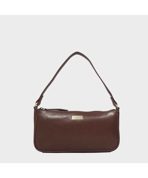 The 'Zera' 80s baguette bag is beautifully handcrafted from full grain genuine leather. This trendy slim leather shoulder bag features a metal zipper on top to ensure your belongings are kept safe and hassle-free. The lightweight mini 'Zera' is a must-have to your retro handbags and is seen styled by most celebrities. Style it up with 'Zera' the perfect compact leather shoulder bag ideal for all events and occasions.
Secured metal zip top closure opens to a fully branded lined interior. Double Stitching on the handles for extra reinforcement. Reinforced base to avoid bulging when stuffed. Leather shoulder handle for easy pick up and go. Adorned with the inimitable Assots London brushed gold clean finish logo demonstrating its premium quality. Fittings colour: Clean Brass. Composition: Body: 100% Genuine Leather. Lining: Polyester lining.
DISCLAIMER: All pictures shown are for illustration purposes only. Actual product colour may vary due to different ambience lighting or the screen display settings. Size- W27.5cm x H14cm x D5cm.