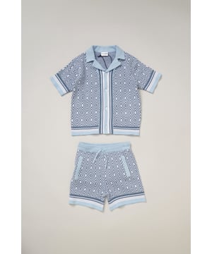 This True Knit resort shirt and shorts set from Norn Studios features a cool patterned design, perfect for summer days and getaways. The lightweight, breathable fabric keeps your little one cool, while the matching shorts complete the relaxed, vacation-ready look. Ideal for sunny adventures and laid-back afternoons.