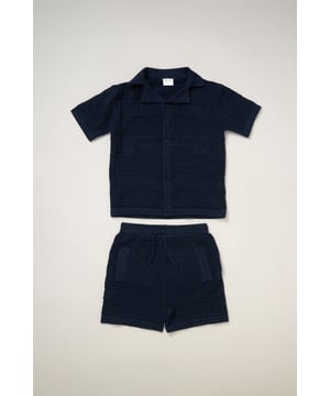 This True Knit resort shirt and shorts set from Norn Studios features a cool patterned design, perfect for summer days and getaways. The lightweight, breathable fabric keeps your little one cool, while the matching shorts complete the relaxed, vacation-ready look. Ideal for sunny adventures and laid-back afternoons.