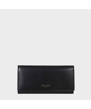 The ‘Claire’ flapover ladies purse is handcrafted with the Assots premium 'Giovani' Italian Polished vegetable tanned leather. Equipped with RFID technology, this practical ladies purse features a magnetic fastening closure with plenty of room to organise your cash, cards and coins. This large leather ladies purse is perfect to compliment your handbag and fits in easily. Stay safe and organised with ‘Claire’ the perfect addition to your collection of purses ideal for all outfits and occasions.
Secured flap over magnetic fastening closure to store your essentials safely and securely. Foldover flap design. Equipped with RFID technology for safety.
Additional back zip pocket to ensure you don’t run out of space. Two note compartments. Eight internal card compartments. Two windowed ID slots. Assots branded lined interiors. Lightweight for easy carry. Fittings Colour: Clean Brass. Composition: Body: 100% Genuine Leather. Lining: 100% Cotton.
DISCLAIMER : All pictures shown are for illustration purpose only. Actual product colour may vary due to different ambience lighting or the screen display settings. Size - W20cm x H10.5cm x D2.5cm.