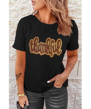 Black Sequined Thankful Round Neck Graphic Tee
  Perfect choice for the holiday season
  Round neck and shift fit for comfortable wear
  Thankful graphic with shiny sequins adds a meaningful message
  Soft and breathable material ideal for layering
  Available in multiple sizes