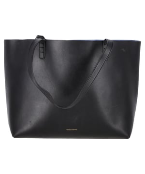 VINTAGE, RRP AS NEW
The Mansur Gavriel Logo Tote Bag in Black Leather is a sleek, versatile accessory that exudes modern luxury. Crafted from smooth, high-quality black leather, this tote features the brand's signature understated logo on the front, offering a perfect balance of elegance and minimalism. With its spacious interior and sturdy, yet refined structure, it's ideal for everyday use, whether at work or on weekends.

Styling Tip: Pair this timeless tote with a classic trench coat and tailored trousers for a polished, professional look. For a more casual vibe, wear it with high-waisted jeans, a simple tee, and loafers. Whether you're carrying it to the office or out for a day of errands, this bag adds a touch of sophistication to any ensemble.

 Mansur Gavriel Logo Tote Bag in Black Leather

Condition: Very good
Signs of wear: Minor signs of wear
Packaging: None
Color: Black
Material: Leather |  leather
Size: One Size | One Size
Measurements: Width: 140; Height: 270; Length: 330; Handle drop: 250; Strap length: 0
SKU: TONPUGBBA456490W