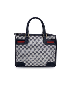 VINTAGE, RRP AS NEW
Step into a world of timeless sophistication with this beautiful vintage Gucci satchel, a true icon of luxury and style. Crafted from the brand's signature blue monogram canvas, this bag is trimmed with rich blue leather, enhancing its elegant and durable design. The standout blue/red/blue stripes on both the front and back are instantly recognizable, adding a touch of sporty chic to the refined silhouette.  With an upper zipper closure, the bag ensures your essentials are securely stored, while the interior is lined with a beige diamond-patterned fabric that speaks to Gucci's commitment to both style and quality. Inside, you'll find a handy side zip pocket for easy organization, keeping your smaller items safe and accessible.  The "Made in Italy by Gucci" tag inside is a mark of ity, confirming the exceptional craftsmanship and heritage of this timeless piece. Whether you're adding it to your collection or making it your everyday go-to, this vintage Gucci satchel will effortlessly elevate any outfit, offering both style and functionality with every use. Condition Rating: B - VERY GOOD CONDITIONCondition Details: Gently used. Some scratches on leather handles and trim. Minimal wear of use on the internal lining. Please check the photos carefully and ask if you need to know more details or if you have any doubts.Measurements (cm):Depth: 15.2Height: 22.9Length: 30.5Other Details: Dustbag? NoKeys? NoBox? No Measurments:  width: 152 mm length: 305 mm height: 229 mm