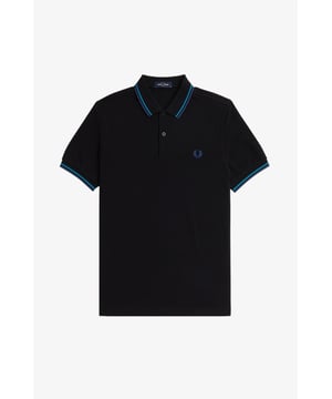 The Twin Tipped Fred Perry Shirt. Made from our classic cotton piqué, in a contemporary adaptation of Fred's famous streamlined fit. Available in a diverse range of colourways - each with their own unique story.
See the Read More section for this product’s key responsible features.
Cotton piqué / Regular fit / Slightly slimmer proportions than the original M12 / Twin tipped collar and cuffs / New two button set-in placket

Our twin tipped piqué shirt was the first to carry our legendary tipping in the 5-4-4 ratio, and it remains at the core of everything we do. An interpretation of our original Twin Tipped Fred Perry Shirt, the M3600 offers a more contemporary adaptation of Fred's famous streamlined fit, with a slightly closer fit. Manufactured on state of the art, modern technology and available in a huge range of colours - each with their own unique story to tell. It comes with a history, and each new generation adds to its legacy. Always different, always the same.
We're looking at ways to reduce our impact on the planet. This product is made with the following key responsible features:
Recycled Tipping & Sewing Threads
Buttons Made from Recycled Materials
Responsibly-Sourced Laurel Wreath Embroidery
To find out more, head to our Community page.
Fred Perry is a proud member of Better Cotton. By choosing our cotton products, you’re supporting Fred Perry's investment in Better Cotton’s mission.
100% Cotton
Machine Wash

Style
M3600
Colour
Night Green/Runaway Bay Ocean/Runaway Bay Ocean