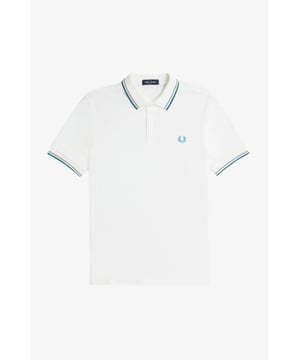 The Twin Tipped Fred Perry Shirt. Made from our classic cotton piqué, in a contemporary adaptation of Fred's famous streamlined fit. Available in a diverse range of colourways - each with their own unique story.
See the Read More section for this product’s key responsible features.
Cotton piqué / Regular fit / Slightly slimmer proportions than the original M12 / Twin tipped collar and cuffs / New two button set-in placket

Our twin tipped piqué shirt was the first to carry our legendary tipping in the 5-4-4 ratio, and it remains at the core of everything we do. An interpretation of our original Twin Tipped Fred Perry Shirt, the M3600 offers a more contemporary adaptation of Fred's famous streamlined fit, with a slightly closer fit. Manufactured on state of the art, modern technology and available in a huge range of colours - each with their own unique story to tell. It comes with a history, and each new generation adds to its legacy. Always different, always the same.
We're looking at ways to reduce our impact on the planet. This product is made with the following key responsible features:
Recycled Tipping & Sewing Threads
Buttons Made from Recycled Materials
Responsibly-Sourced Laurel Wreath Embroidery
To find out more, head to our Community page.
Fred Perry is a proud member of Better Cotton. By choosing our cotton products, you’re supporting Fred Perry's investment in Better Cotton’s mission.
100% Cotton
Machine Wash

Style
M3600
Colour
Snow White/Warm Grey/Ocean