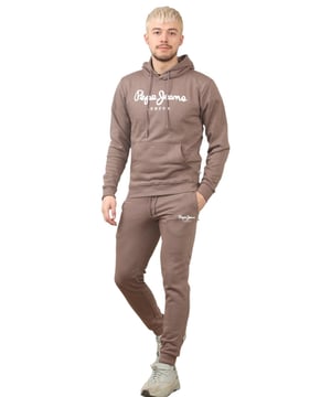 The Pepe Jeans London men's regular fit tracksuit set offers a soft and lightweight hoodie paired with matching joggers. The hoodie features ribbed details on the hood, cuffs, and hem, along with an adjustable hood and a kangaroo pocket for convenience. The joggers come with a waistband drawstring for a secure fit. Both pieces showcase the Pepe Jeans London Big logo on the chest for the hoodie and the small logo on left leg for the joggers. A decorative inner neckband with an all-over logo adds a stylish touch. Made from 100% sustainable cotton, the fabric consists of 65% cotton and 35% polyester. The set is a washable machine for easy maintenance.