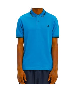 The Twin Tipped Fred Perry Polo Shirt by Fred Perry is a short sleeved polo shirt that has been made from Fred Perry's classic cotton piqué, in a contemporary adaptation of Fred's famous streamlined fit. Available in a diverse range of colourways - each with their own unique story. Featuring the signature Fred Perry wreath logo to the chest and twin tipping to the collar and cuffs.
