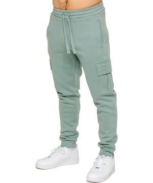 Experience superior comfort and style with Enzo Men's Regular Fit Cargo Joggers! Crafted with a brushed back inner fleece lining, these joggers are designed to keep you cozy all day long. Perfect for casual wear, they feature convenient 2 side slash pockets and 2 cargo pockets, providing ample storage space for your essentials. Stay on-trend with the cuffed leg design, offering a modern silhouette and added comfort.