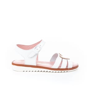 Unas sandalias sofisticadas, suaves y flexibles. Zapato tipo sandalia fabricado en napa de piel bovina con adorno de corazones en la pala y sistema de cierre de hebilla. La parte interior está fabricada con forro de piel natural, planta con puente anatómico y suela de goma antideslizante. Calzado diseñado y fabricado en España.