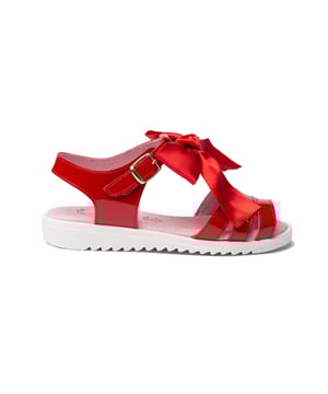 Verfijnde, zachte en flexibele sandalen. Sandaalachtige schoen van rundernappaleer met strikversiering op de bovenkant en gespsluiting. De binnenkant is gemaakt van een voering van natuurlijk leer, een binnenzool met anatomische brug en een antislip rubberen zool. Schoenen ontworpen en vervaardigd in Spanje.