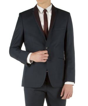 This striking navy twill suit jacket is cut on a slim fit block and has a contrasting burgundy panel on the notch lapels ensuring you turn heads in the crowd. The jacket features a two button fastening, notch lapels, jetted side pockets, side vents and four button cuffs. Styling details include a navy printed body lining which also features as a pull out pocket handkerchief and on the under collar alongside a tonal navy collar melton.