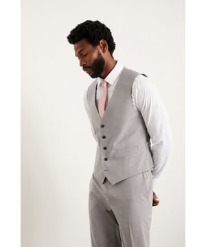 Embrace the versatility of this slim fit waistcoat by pairing it with a crisp dress shirt, tailored trousers, and a matching blazer for a complete and polished look. Whether you're dressing up for a formal event or looking to add a touch of elegance to your everyday attire, this waistcoat is the perfect choice. Elevate your style and exude confidence with this exceptional piece.