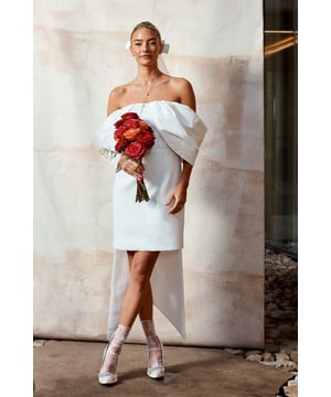 Striking Bardot neckline with elegant off-shoulder design
        Luxurious taffeta crepe fabric for a sophisticated look
        Dramatic cape-like sleeves that drape beautifully
        Figure-flattering mini length with a chic high-low hem
        Stunning bow detail at the back for added allure
    
    Make a lasting impression on your special day with this captivating Bardot mini dress from Coast. The statement off-shoulder neckline and flowing cape sleeves create a romantic silhouette that's perfect for the modern bride. The taffeta crepe fabric offers a luxurious sheen and structure, ensuring you look radiant as you walk down the aisle. The mini length showcases your legs, while the high-low hem adds drama and movement. Style with strappy heels and delicate jewellery for a look that's both contemporary and timeless. Whether you're saying 'I do' at a chic city venue or a picturesque countryside setting, this dress will ensure all eyes are on you as you celebrate your love story in style.