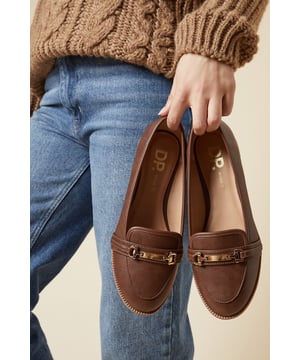 Wide fit design for enhanced comfort
        Sleek snaffle detail adorning the vamp
        Flat heel measuring between 0 and 2cm
        Faux leather construction for a polished look
        Versatile loafer style suitable for various occasions
    
    Step out in style and comfort with these chic Lora Snaffle Loafers from Dorothy Perkins. Perfect for the fashion-conscious woman who values both trend and practicality, these wide fit flats offer a seamless transition from day to night. The classic loafer silhouette is given a modern twist with the eye-catching snaffle detail, adding a touch of sophistication to any ensemble. Pair them with tailored trousers and a crisp blouse for a polished office look, or dress them down with your favourite jeans for a casual brunch with friends. The versatile design makes these loafers an ideal choice for baby showers or dinner dates, effortlessly complementing a variety of outfits. With their flat heel and comfortable fit, these loafers are perfect for those busy days when you're on your feet but don't want to compromise on style.