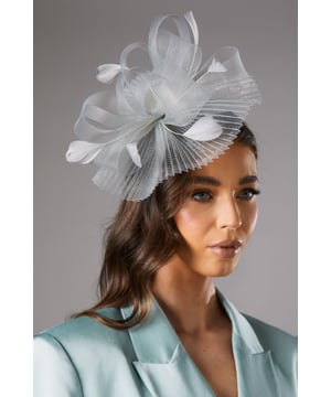 Exquisite pleated loop and feather design
        Elegant fascinator for special occasions
        Intricate layered construction for depth and volume
        Lightweight and comfortable to wear
        Versatile accessory to complement various outfits
    
    Make a striking impression at your next formal event with this captivating pleated loop and feather fascinator from Coast. This meticulously crafted hair accessory showcases a harmonious blend of delicate pleats, graceful loops, and wispy feathers, creating a mesmerising focal point for your ensemble. Perfect for weddings, race days, or any sophisticated soire, this fascinator adds a touch of refinement to your look. Style it with an elegant updo or flowing locks, pairing beautifully with a tailored blazer and sleek trousers for a modern twist on occasion wear. Alternatively, complement a flowing midi dress for a more traditional approach. This versatile piece allows you to express your personal style whilst maintaining an air of sophistication, ensuring you stand out for all the right reasons at your next celebratory gathering.
