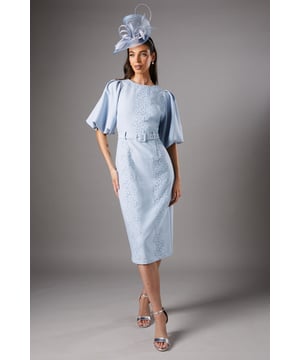 Exquisite lace detailing adorns the bodice for a touch of elegance
        Dramatic puff sleeves create a striking silhouette
        Belted waist accentuates the figure and adds definition
        Midi length offers a sophisticated and versatile option
        Round neckline provides a classic and flattering finish
    
    This stunning Coast dress embodies refined elegance, perfect for those special occasions that demand a touch of sophistication. The intricate lace detailing on the bodice adds a delicate charm, while the voluminous puff sleeves create a dramatic and eye-catching silhouette. The belted waist cinches in to flatter your figure, ensuring a sleek and defined look. Ideal for weddings, race days, or formal events, this dress can be styled with a statement fascinator and metallic heels for a truly show-stopping ensemble. The versatile midi length allows for ease of movement without compromising on style, making it a go-to choice for various social engagements. Elevate your look with minimalist jewellery to let the dress's exquisite details shine.