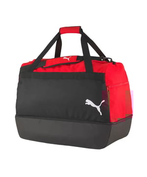 The Puma TeamGoal 23 Black/Red Hardcase Bag is designed for athletes who need a tough, durable, and spacious bag to carry their gear. With a strong hardcase structure and ample storage space, this bag ensures your equipment stays safe and organized during transport. Whether you're heading to a match, training, or traveling, this bag provides superior protection for your gear, all while offering a sleek, stylish design.
Key Features:
Hardcase Structure: 

The hardcase construction provides added protection for your sports equipment, ensuring that your gear is safeguarded from external damage during travel or handling.


Large Capacity: 

The bag offers ample storage space, allowing you to easily store your football gear, clothing, shoes, and other essentials. Itâ€™s perfect for athletes who need to carry multiple items at once.


Durable Design: 

Made from high-quality, durable materials, this bag is built to withstand frequent use, ensuring long-lasting performance even in demanding environments.


Multiple Pockets: 

Equipped with side zip pockets and a front compartment, the bag helps you organize smaller items like keys, phone, or accessories, keeping everything easily accessible.


Comfortable Carrying Options: 

The bag features padded shoulder straps and reinforced carry handles, providing various options for comfortable and secure transportation.


Sleek Black/Red Colorway: 

The black and red design gives the bag a bold, sporty look, making it easy to match with your other sportswear or equipment.


Puma Branding: 

The Puma logo is prominently displayed, showing off your connection to a trusted brand in sports gear and athletic accessories.


The Puma TeamGoal 23 Black/Red Hardcase Bag is the perfect choice for athletes who need a durable, spacious, and protective bag for their gear. With its hardcase design, multiple compartments, and stylish colorway, it offers both functionality and a modern look. Whether you're traveling for a match or heading to training, this bag has everything you need to keep your gear safe and organized.