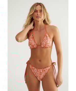 Delicate lace fabric with intricate floral pattern
        Halterneck triangle top with ruffle detailing
        Tie-side bikini bottoms for adjustable fit
        Two-tone design for added visual interest
        Flattering cut to enhance feminine silhouette
    
    Make a splash this summer with NastyGal's captivating Lace 2 Tone Ruffle Triangle Bikini Set. This alluring swimwear piece combines romantic lace with a daring cut, perfect for those who want to turn heads at the beach or poolside. The halterneck top features charming ruffle detailing, adding a touch of playfulness to your look. The tie-side bottoms allow for a customised fit, ensuring comfort throughout your sun-soaked adventures. Ideal for a tropical getaway or a day at the lido, this bikini set is versatile enough to take you from lounging by the pool to sipping cocktails at a beachfront bar. Layer with a sheer kaftan and slip-on sandals for a chic resort ensemble, or pair with high-waisted shorts and oversized sunglasses for a trendy beach club look. Whatever your summer plans, this NastyGal bikini set is sure to be your go-to choice for sultry sophistication.