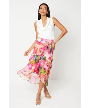 Chiffon wrap skirt with vibrant floral print
        Asymmetrical hemline with cascading ruffles
        Flattering wrap design with side tie closure
        Lightweight and flowing fabric for graceful movement
        Midi length perfect for various occasions
    
    Embrace elegance and sophistication with this stunning chiffon wrap skirt from Coast. The eye-catching floral print radiates femininity and charm, making it an ideal choice for weddings, race days, or any special event. The asymmetrical hemline adorned with cascading ruffles adds a touch of drama and movement to your ensemble. Style this versatile piece with a crisp white blouse and strappy metallic heels for a polished look that's sure to turn heads. For a more relaxed yet chic daytime outfit, pair it with a fitted tank top and delicate sandals. The lightweight chiffon fabric ensures comfort and graceful movement, while the wrap design flatters your silhouette. Whether you're attending a garden party or a formal celebration, this skirt will help you convey effortless elegance and refined taste.