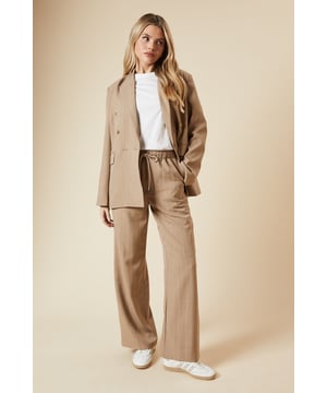 Elasticated waistband for comfort and ease
        Wide leg silhouette for a relaxed, on-trend look
        Vertical pinstripe pattern elongates the figure
        Side pockets for practicality
        Versatile length suitable for various heights
    
    Embrace effortless style with these Dorothy Perkins wide leg trousers. The elasticated waist ensures all-day comfort, perfect for those busy days running errands or meeting friends for a casual brunch. The pinstripe pattern adds a touch of sophistication, making these trousers easily dressed up or down. Pair with a crisp white t-shirt and trainers for a relaxed weekend look, or team with a blouse and ballet flats for a smart-casual office ensemble. The wide leg cut is not only on-trend but also flattering for various body types. These trousers are ideal for family gatherings or casual outings where you want to look put-together without sacrificing comfort. The versatile design makes them a wardrobe staple that you'll reach for time and time again.