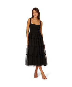 Modern fabric mixes make this classic fit and flare dress a sweet look. This midi dress features a fitted bodice with tank straps, a square neckline, and a tiered skirt. Fully lined, the bodice is crafted from a knit fabrication while the skirt is overlaid in mesh for added sweep. Pockets and a square back with centre zip closure complete this delightful party dress. Styled with nude heels and sparkling accessories, this midi dress is a timeless look from wedding guest duty to cocktail parties