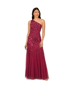 Brighten every ball room you step into in this one shoulder mermaid gown. This formal dress features a fitted bodice, one shoulder neckline, and a mermaid skirt with godet pleats. Crafted from knit mesh that is adorned with stunning sequin beaded florals and the edges are trimmed with lines of tight beading that fades mid-skirt. A hidden zipper closure at the centre back completes this black-tie dress.