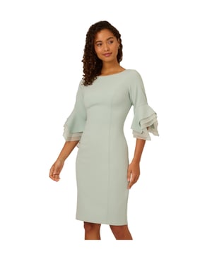 Dressed up meets versatile in this timeless sheath dress. This midi dress features a boat neckline, fitted silhouette through the body, and tiered three-quarter bell sleeves with organza accents. Crafted using knit crepe, this day dress has some stretch and no waist seam for a comfortable fit. A zipper back closure and a single pleat at the centre back of the skirt hem completes the design.
