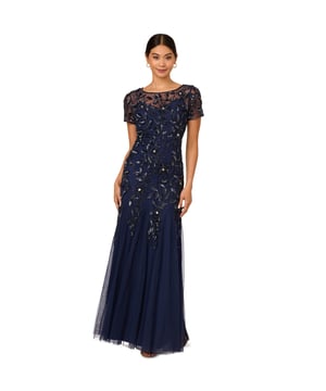 A work of art: our long and romantic gown dazzles with all-over handsewn beading in a feminine floral pattern that catches the light with every twirl. A streamlined silhouette is eased with the mermaid skirt with godets to create the right amount of movement. All the details: our iconic (and flattering) no waist seam, sheer illusion yoke and cap sleeves. Sleek back zip closure.