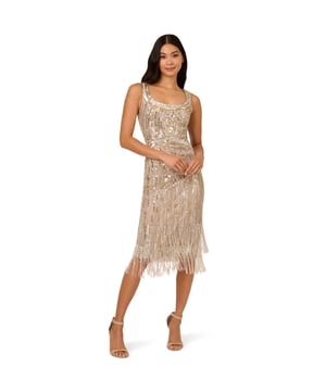 The all-over linear sequin and bead embellishment on this shimmering sleeveless cocktail dress defines your waist and bust with clever pattern placement. The star of the show is the fringe hem with two layers of beaded fringe to give the look lots of extra sparkle. A back zipper finishes the design. Wear this dress anytime you are planning to hit the dance floor, because this style is made to catch the light with every movement.