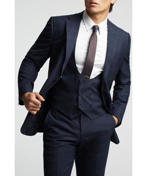 A classic recapture of British tailoring - Alexandre of England present the Navy Textured Check tailored fit suit jacket. Made with pure wool, for guaranteed comfort and style for your next formal occasion.With a sleek single-breasted, two button fastening, this jacket also features a notch lapel, 2 straight flap pockets and printed lining for added impact.Pair with the matching trousers and waistcoat for head-to-toe sophistication.