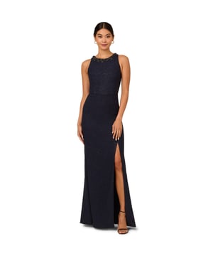 Sleek and sophisticated, this womens navy gown design creates texture and sparkle with a boucle fabric shot through with metallic thread for a glittering effect. A back zipper closure creates the fitted mermaid gown silhouette with an above-the-knee side slit for comfortable movement. The crew neckline is trimmed in rhinestone beading for a built-in jewellery look, adding a final touch of opulence to this elegant blue evening dress.