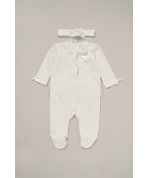 This Charming Ribbon Detail All-In-One Set from Rock A Bye Baby Boutique features a button-up all-in-one adorned with a lovely rose ribbon, complete with matching headband also adorned with a rose ribbon. Adding to its adorable charm, the set features a tutu skirt on the back, enhancing its sweet appeal. Each set also comes with a hanger, ensuring easy storage and display.