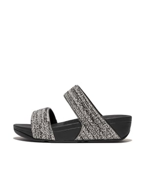 De Lulu slippers van FitFlop zijn klassiekers. Blijvend populair, ze zijn zacht gevoerd en kunnen omhoog of omlaag gekleed worden. Ze staan op FitFlop's legendarische super dempende Microwobbleboard™ tussenzool. Dit seizoen uitgevoerd in een glinsterende structuurstof met een chique 'tweedy' uitstraling. Afgerand met metallic parelmoeren biezen van imitatieleer voor extra glans. Subtiel glinsterende sandalen die je overal bij kunt dragen en prachtig zijn van dag tot nacht.