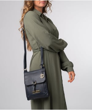 The 'Naomi' cross body bag from Pure Luxuries London is crafted from leather that has a soft pebble grain finish. The fold over top conceals the 100% untreated cotton lined compartment which is complemented by pockets on the interior and exterior of the bag, providing organised storage for all of your essentials. Comes with an adjustable and matching leather strap to suit your needs. Adorned with eye-catching gold coloured fittings and finished with the Pure Luxuries London charm and logo.